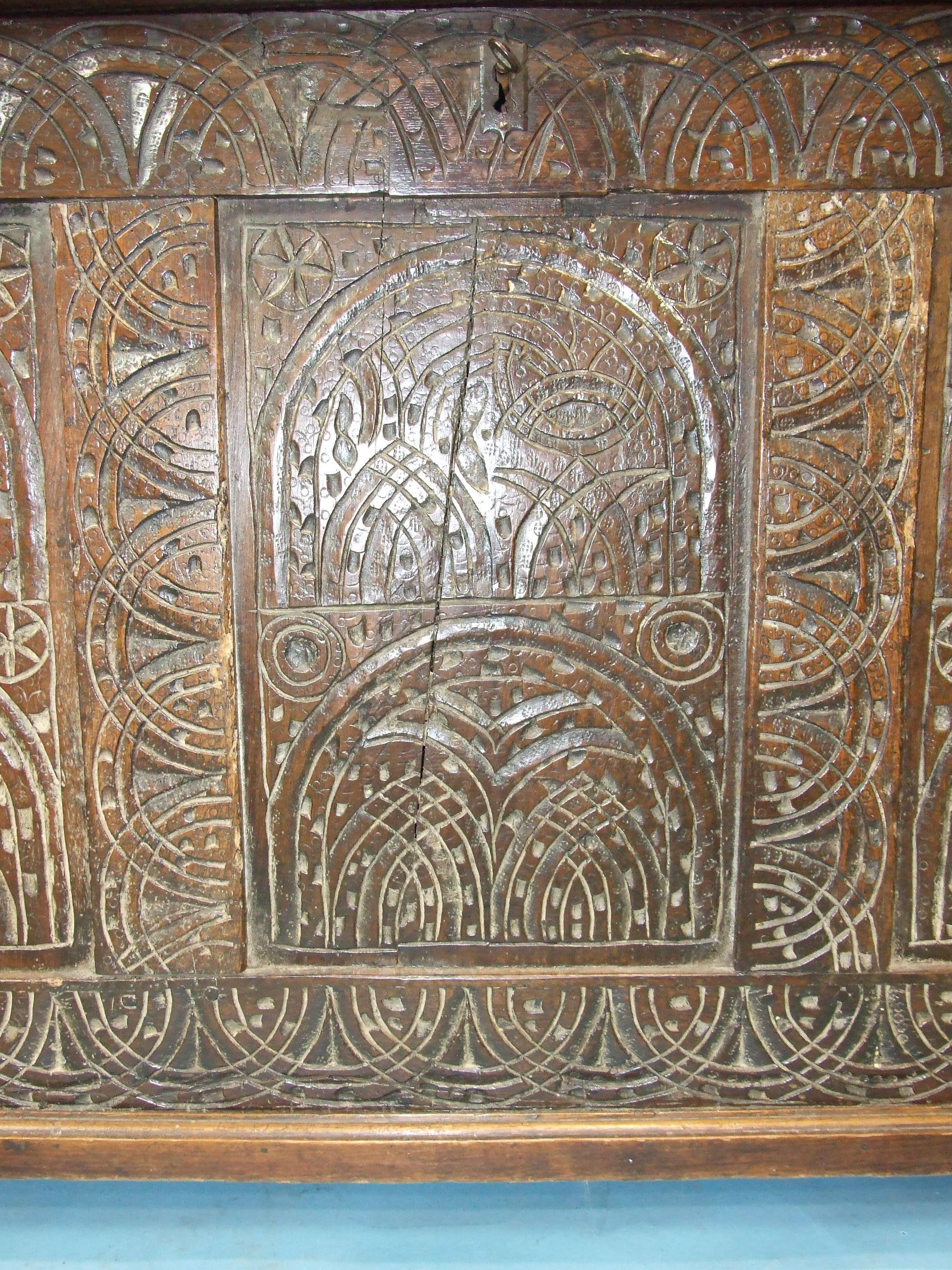An antique oak coffer, the later top above carved front panels and later bracket feet, 127cm wide, - Image 2 of 2