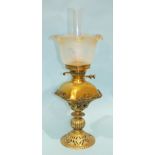 A late-19th/early-20th century oil lamp, the domed rectangular brass reservoir and later etched