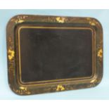 A toleware rectangular tray, the border decorated with gilt flowers and foliage, 77 x 58cm.