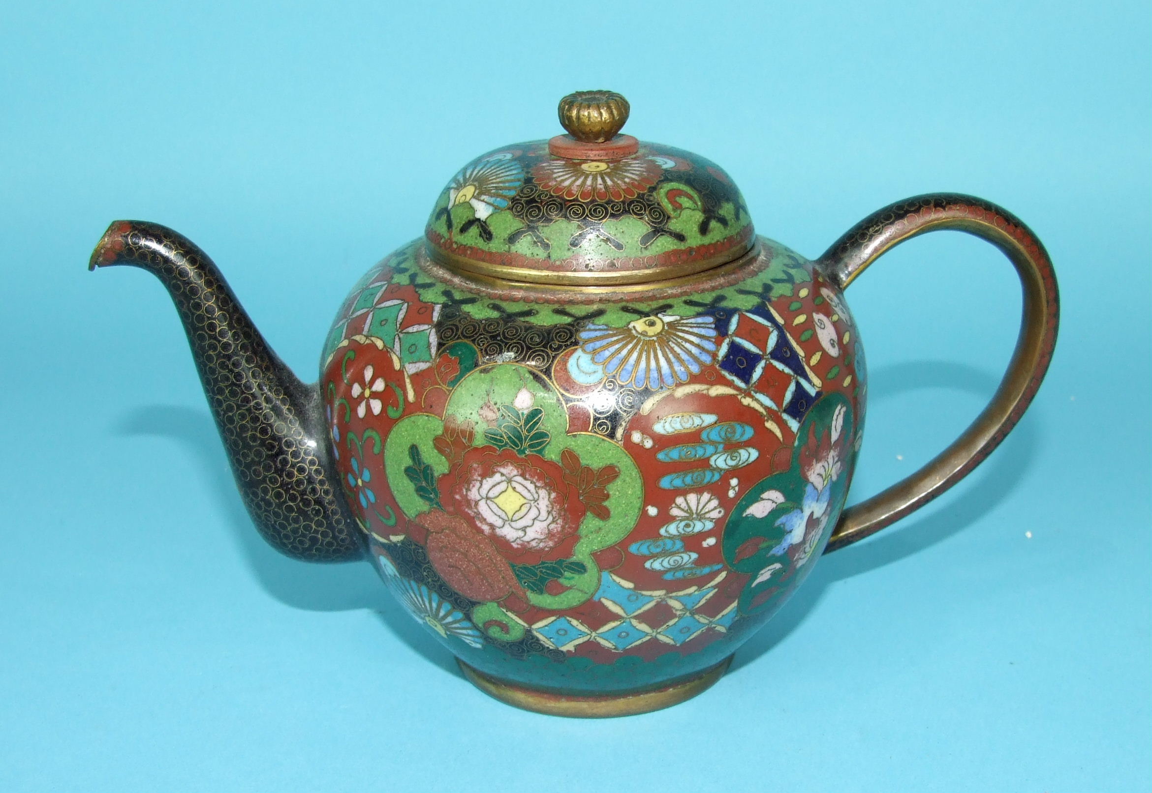 A 19th century Chinese cloisonné teapot and cover decorated with panels of flowers, on a brocade - Image 2 of 3