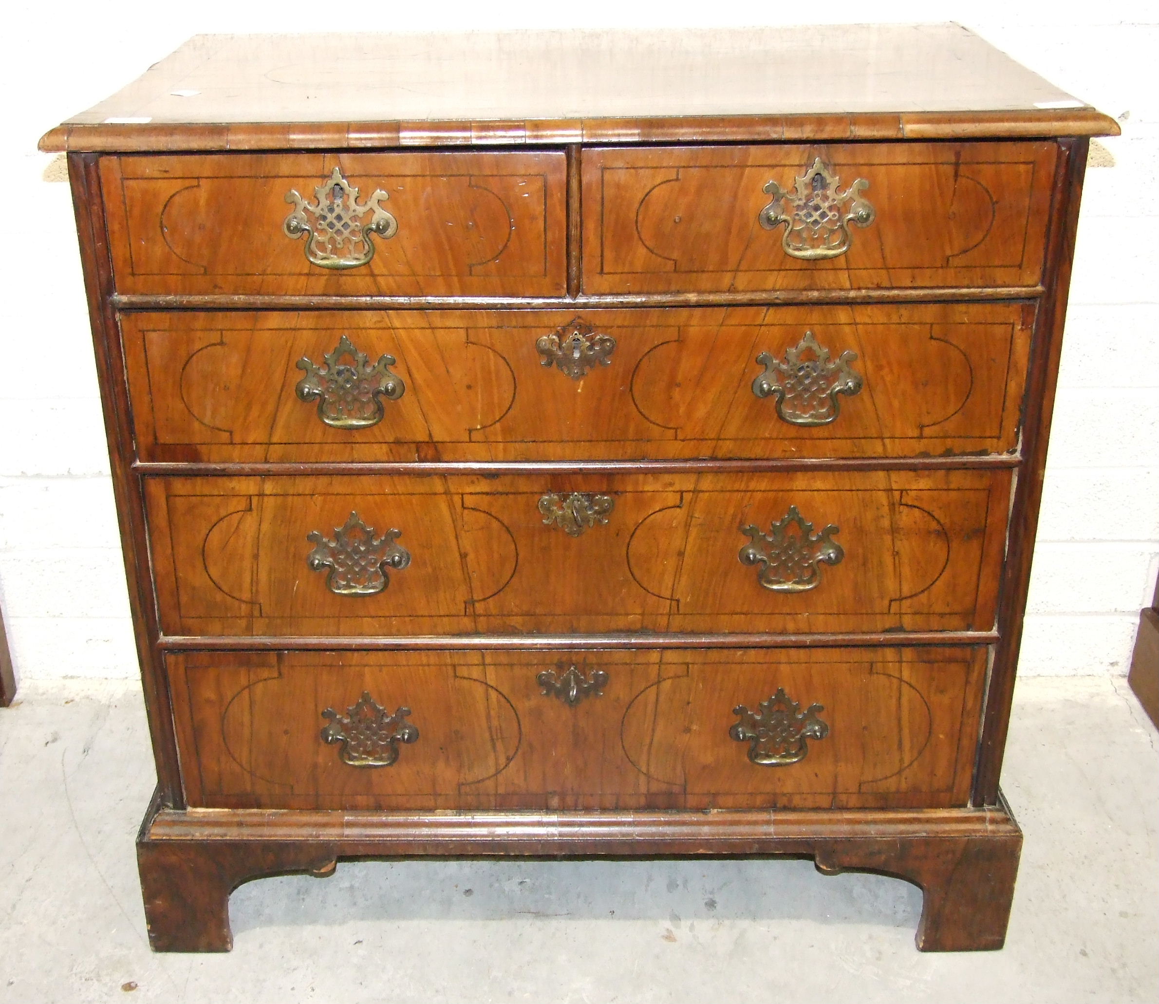 A 17th/18th century inlaid walnut rectangular chest of two short and three long drawers, on