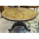 A Victorian walnut circular dining table on hexagonal baluster column and carved tri-form