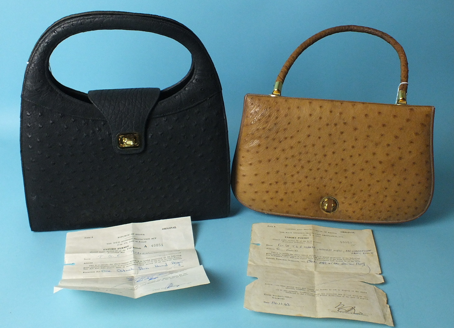 A tan Ostrich leather handbag with Kenyan export permit dated 1963 and another, black, with permit
