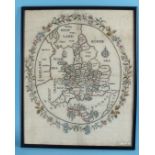 A 19th century needlework map sampler worked in coloured threads on ivory background, depicting