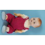 A large German composition baby doll with sleeping blue eyes and dressed character body, (a/f,