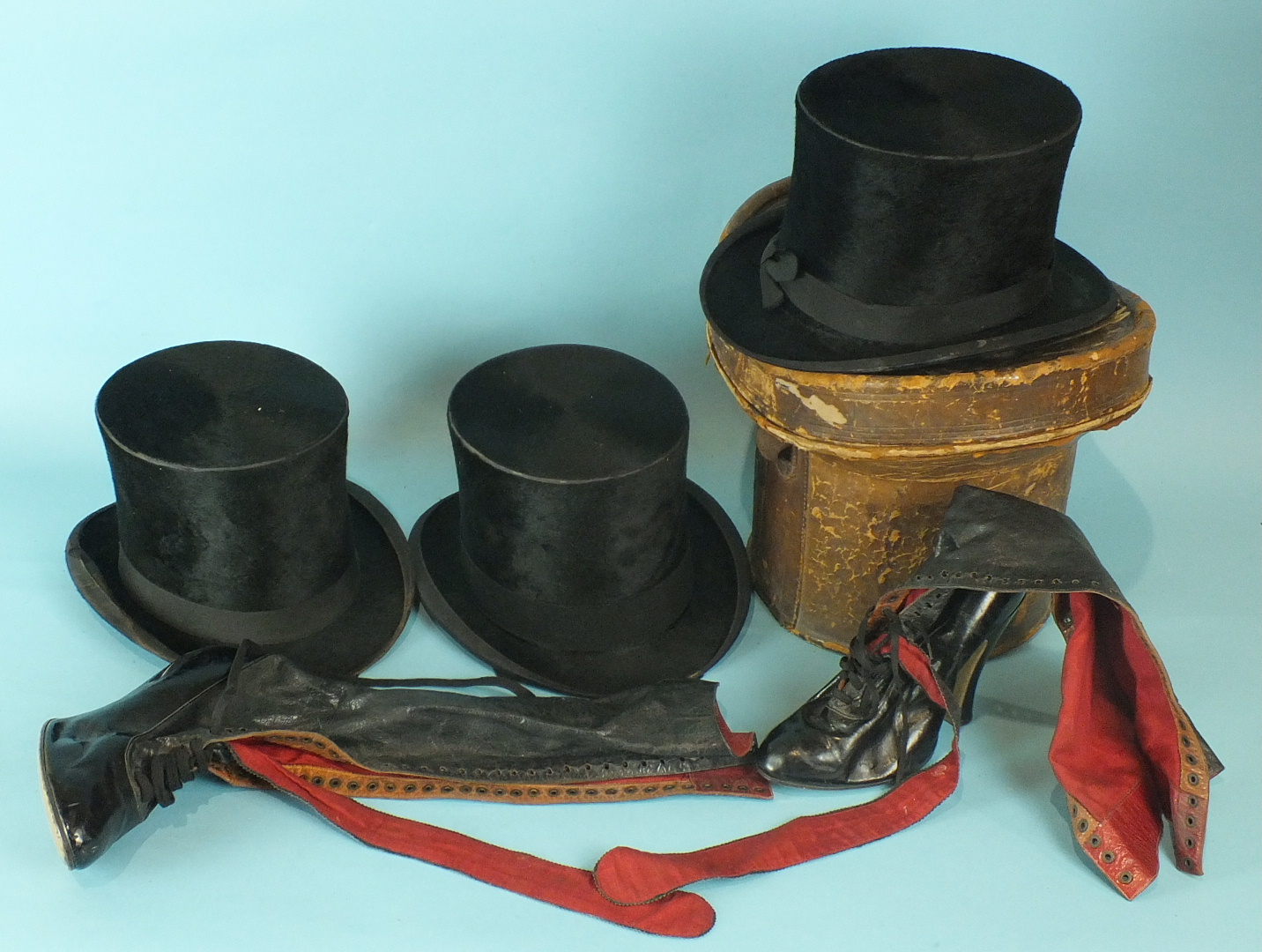 Three black silk top hats, one in leather box, a pair of ladies leather fashion boots with laced