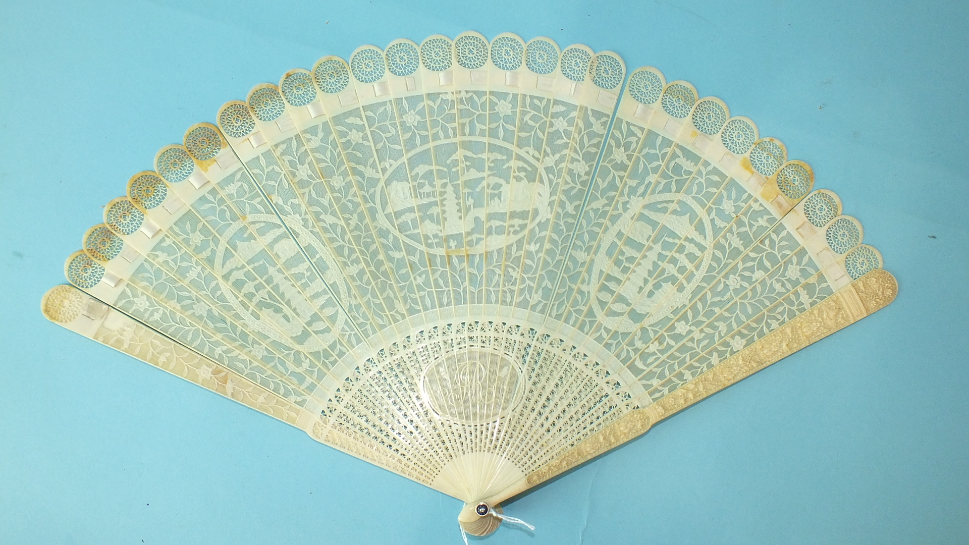 A 19th century Chinese carved ivory brisé fan, the guards carved with flowers and birds, the brisé