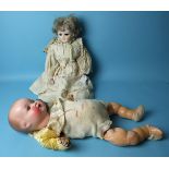 A large Armand Marseille baby doll with composition head and body marked 'AM Germany 518/6k', 55cm