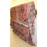 An Afghan Kilim rug in pale red and dark colours, 310 x 200cm and two other 20th century rugs, (3).