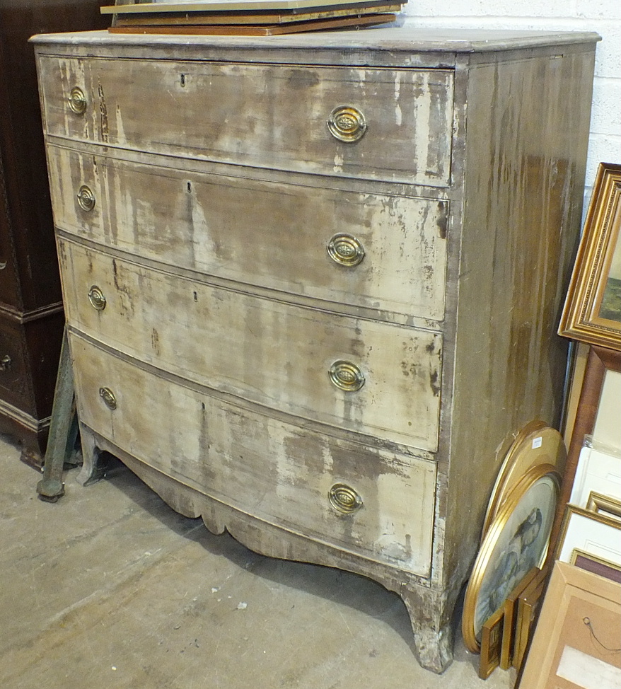 A late-18th century mahogany bow-fronted chest of four long cockbeaded drawers and ebony-lined