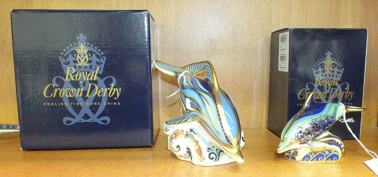 A Royal Crown Derby boxed 'Stripe Dolphin' paperweight and a boxed 'Baby Dolphin', both with gold