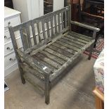 A weathered teak slatted-seat-and-back garden bench, 115cm wide.