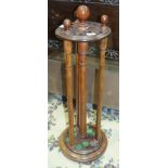 A reproduction stained wood revolving Billiard cue stand on circular base, 98cm high.
