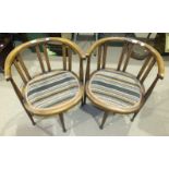 A pair of stained inlaid mahogany armchairs, each with padded seat on turned legs, a carved square-
