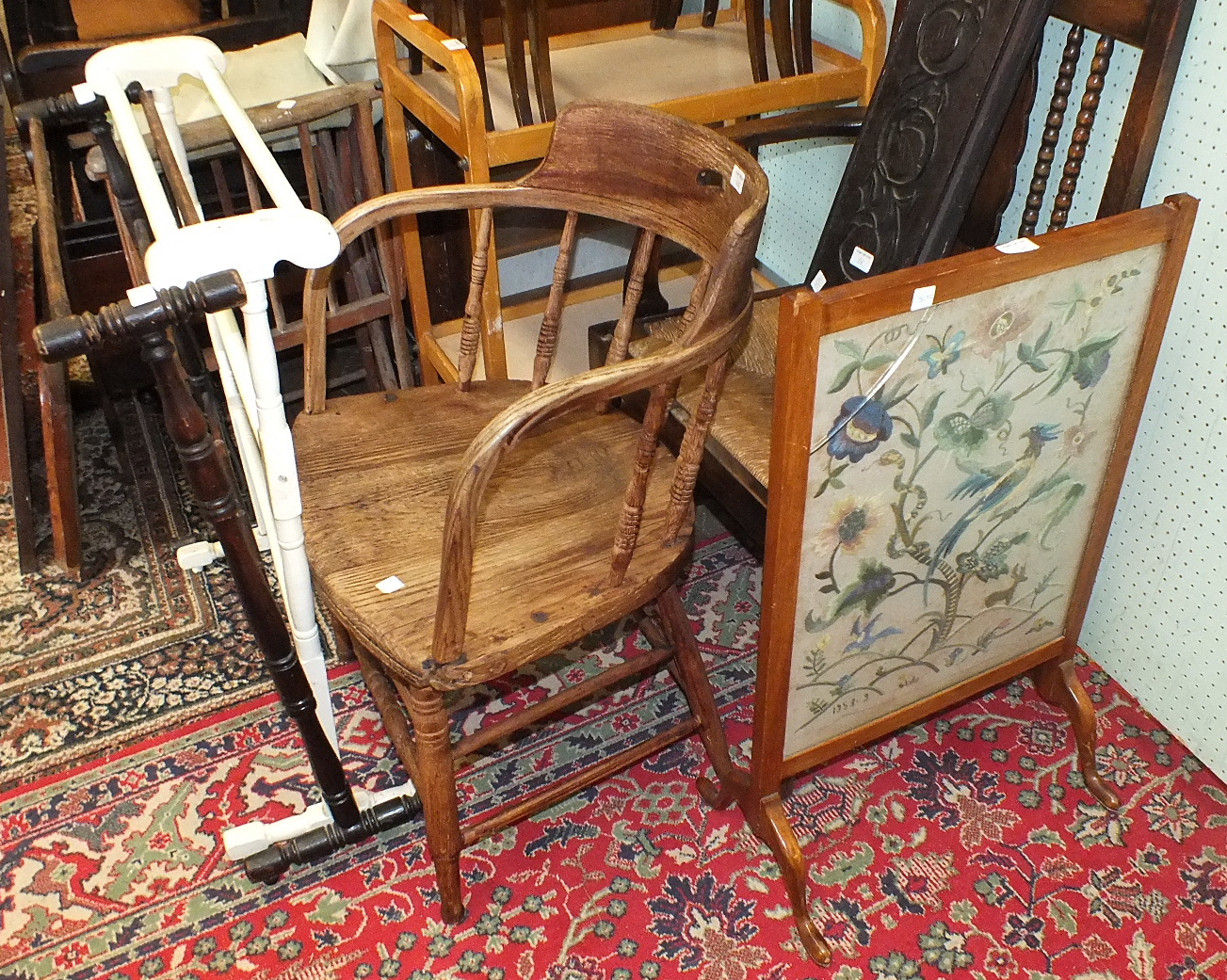 A rush-seated carver chair with bobbin-turned front legs, an elm armchair, two wooden towel rails, a