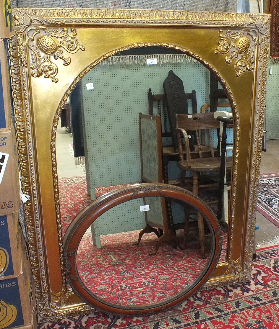 An arched mirror in gilt frame, 101 x 128cm and an oval mirror, (2).