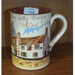 A pottery tankard decorated with "The Jolly Sailor, 15th cent, Looe Inn" and motto 'Down Along O'