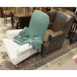 A Victorian upholstered salon chair on turned walnut feet and a Rexine-covered wing armchair, (2).