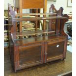 A set of stained mahogany wall shelves fitted with two cupboard doors, 60cm wide, a set of three-