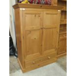 A modern pine cupboard fitted with two doors above a single drawer, 101cm wide, 145cm high.
