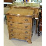A reproduction bow-fronted walnut chest of four drawers, 55cm wide and a reproduction walnut knee-