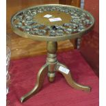 A heavy brass trivet, the pierced circular top on tripod support, 27.5cm diameter, 28cm high.