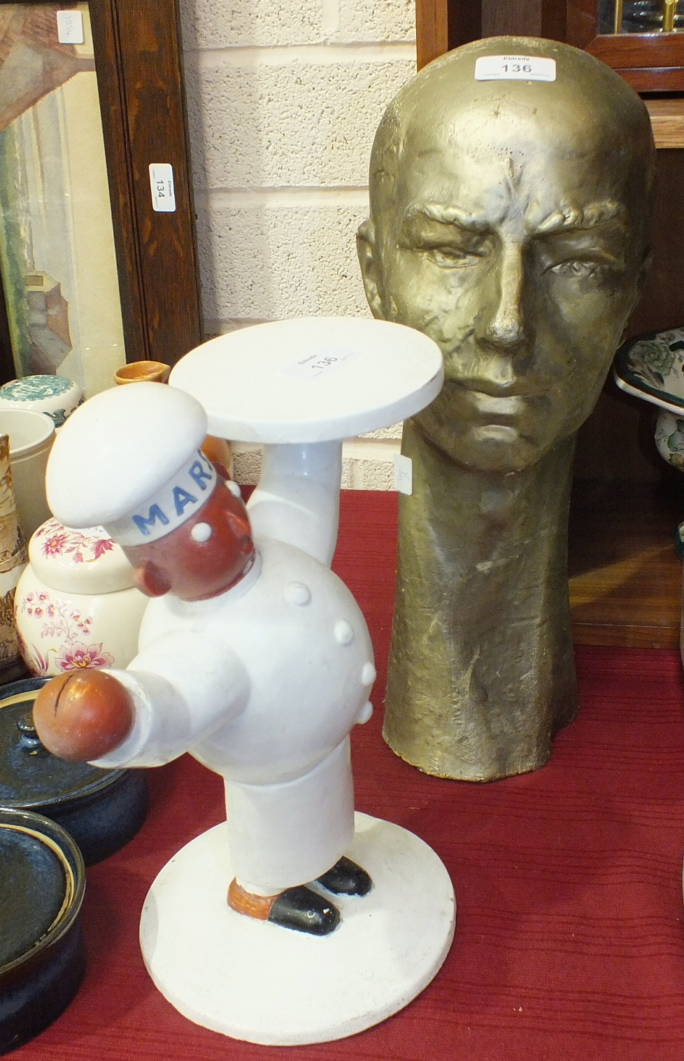 A plaster shop advertising figure of a baker in whites, his chef's hat inscribed 'Marsh', one hand