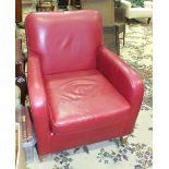 A modern leather-upholstered armchair with loose cushions, (complies with 1988 Fire Regulation