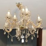 A modern glass nine-branch chandelier with lustre drops, 61cm high, 61cm diameter.