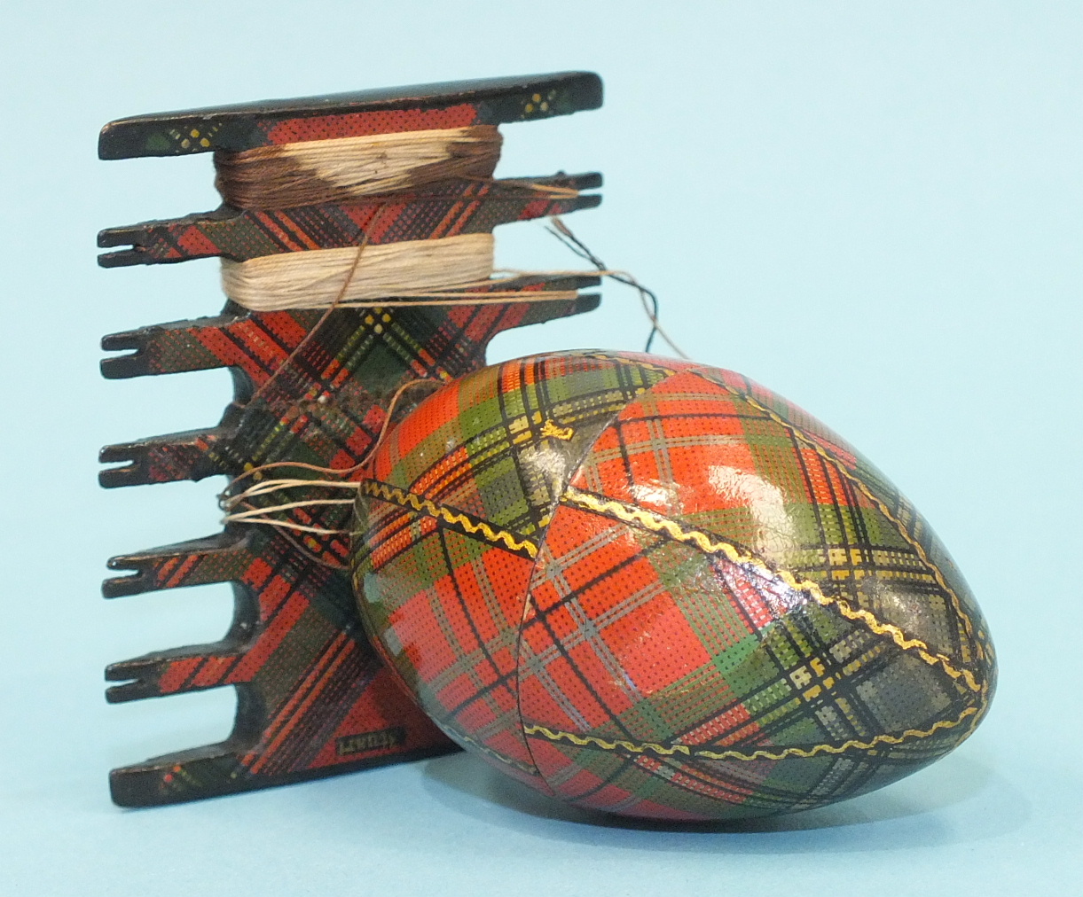 A Tartanware egg-shaped spool box, (McLean), 5cm, a comb-shaped thread winder, (Stuart), 5cm, two