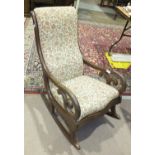 A late-19th/early-20th century mahogany frame rocking chair with scroll arms and upholstered seat