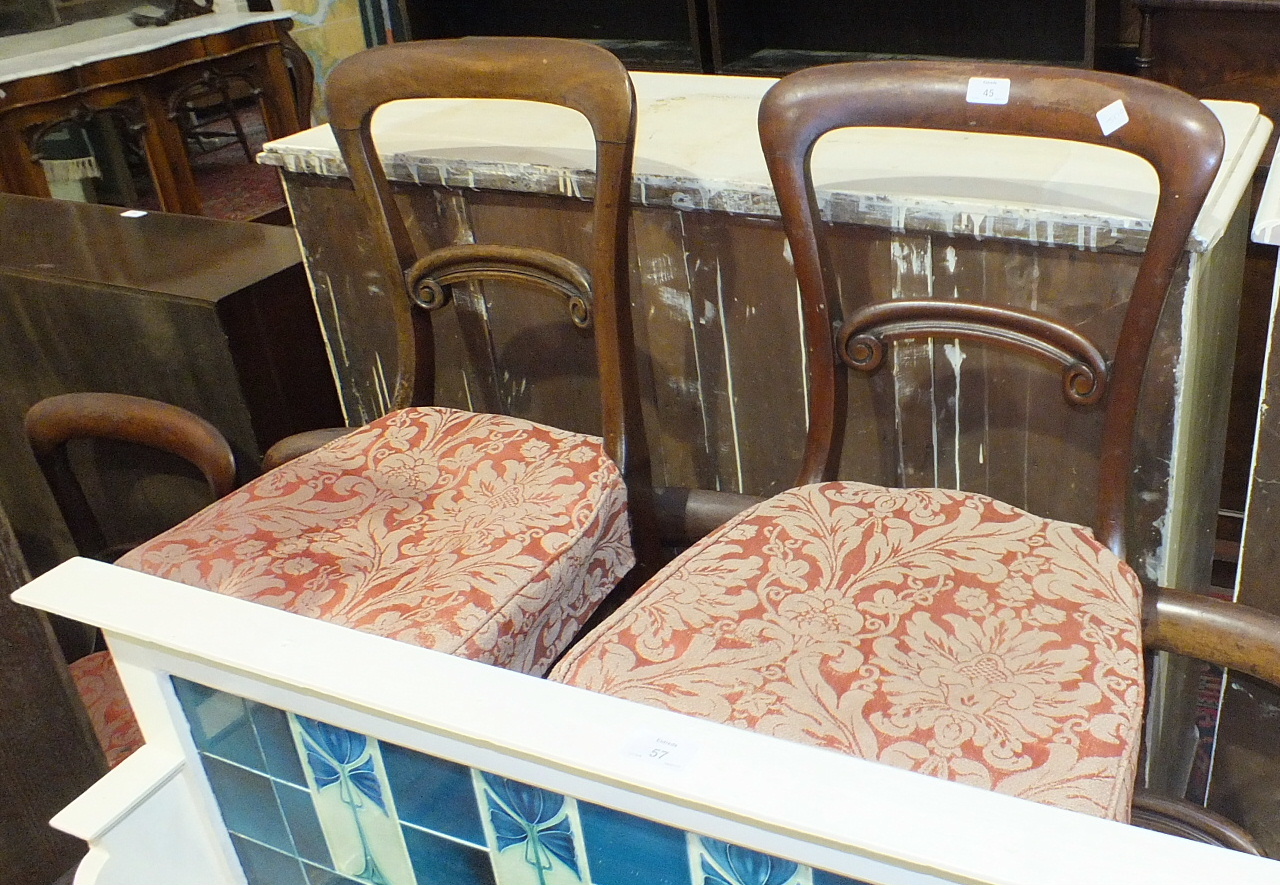 Nine Victorian mahogany balloon-back dining chairs, each with curved back and carved rail, on