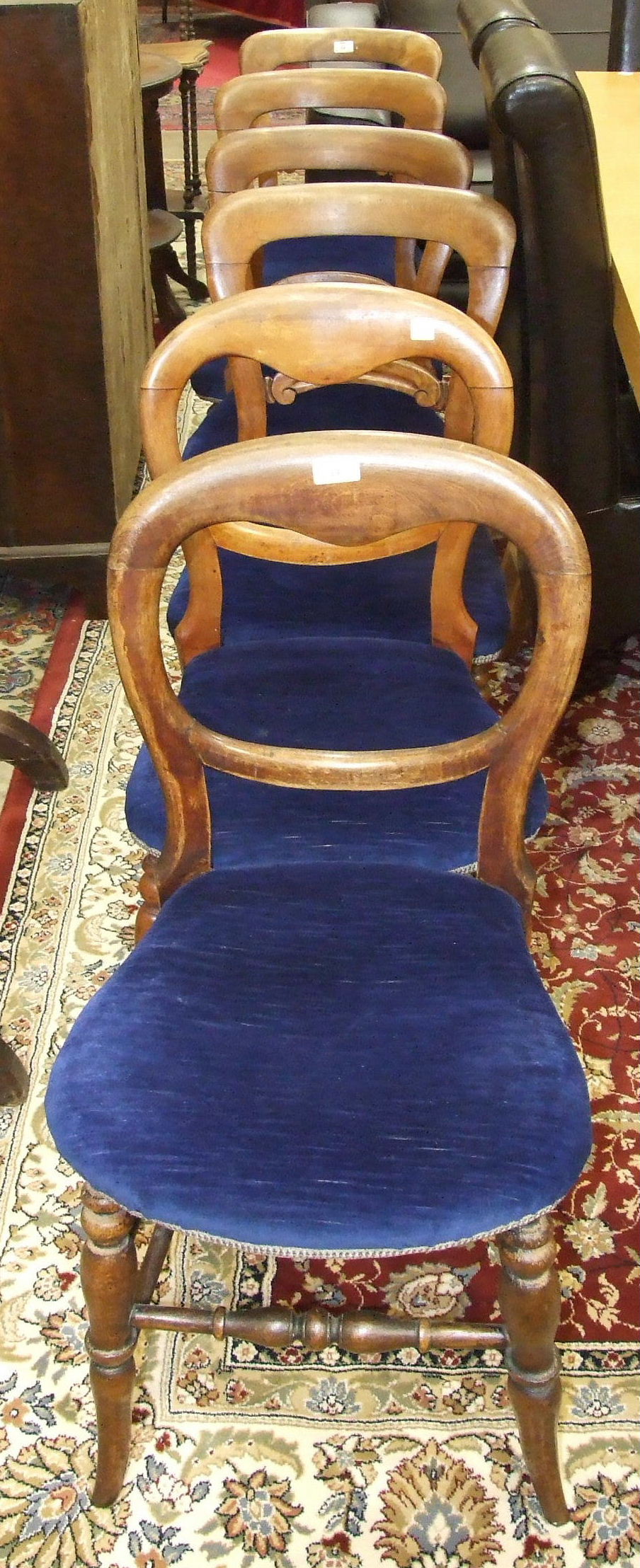 A set of four Late-Victorian stained wood dining chairs on turned front legs and a pair of similar