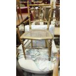 A late-19th/early-20th century upholstered nursing armchair on turned front legs, a pair of