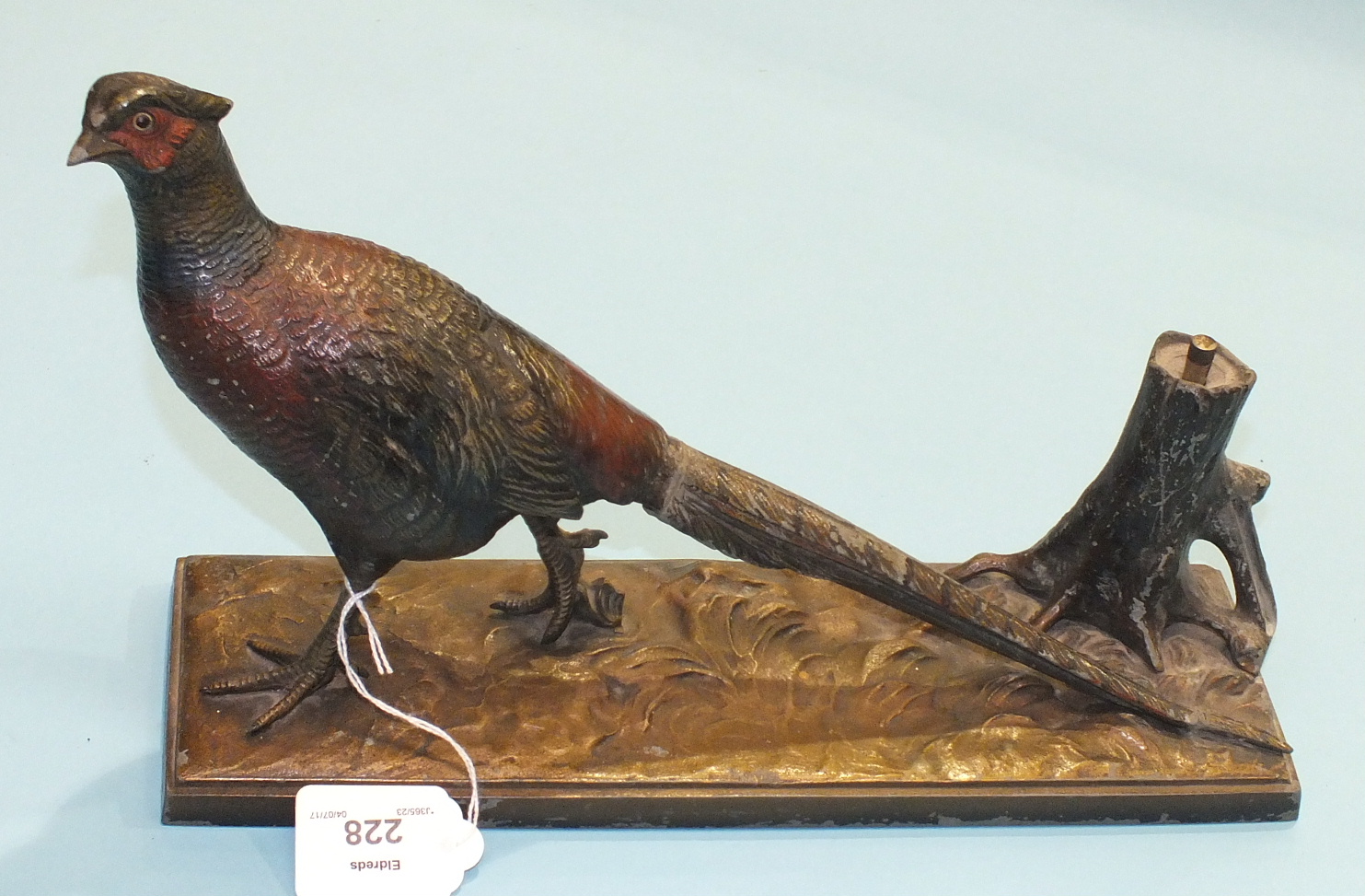 An Art Deco cold-painted table lighter cast as a pheasant beside a tree stump, on wooden base, 31.