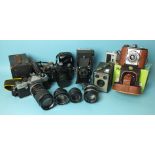 A collection of cameras and lenses, including Praktica TL3, Zenit EM and Kershaw Eight-20 Penguin.