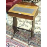 An Edwardian inlaid mahogany desk, the hinged sloping top above two end supports, 56cm wide, 86cm