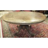 A mid-19th century rosewood breakfast table, the oval top on carved bulbous column, on quadruped