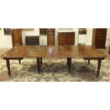 An early-19th century extending mahogany dining table, the rectangular top on pull-out action,