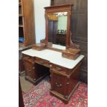 A Continental walnut dressing chest, the carved rectangular mirror and two small drawers on white