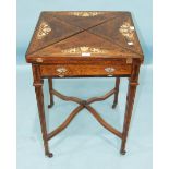 A Late-Victorian rosewood envelope card table, the folding top inlaid with boxwood and ivory urns