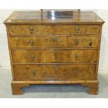 An early-18th century walnut chest, the cross-banded and quarter-veneered top above two short and