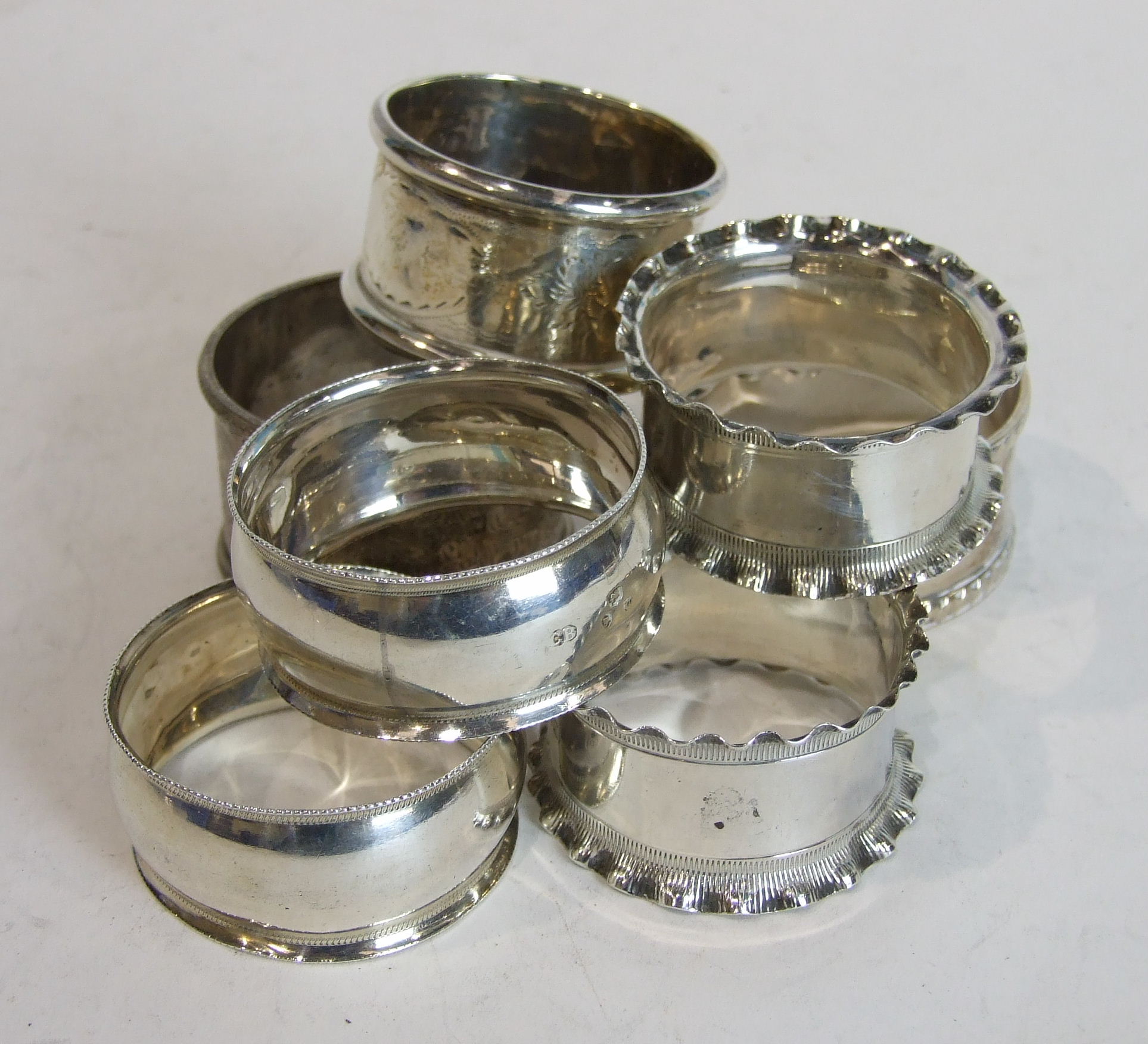 A pair of silver napkin rings, Birmingham 1904, one other pair, London 1915 and three others,