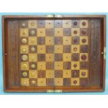 J Jaques & Son, a travelling chess board with retained turned ivory pieces within the folding board,