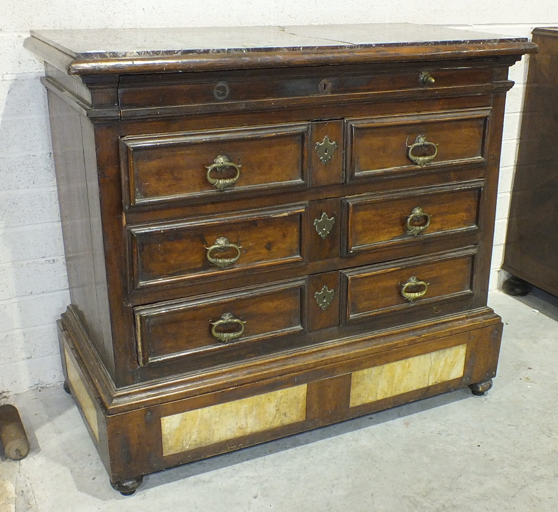 An 18th century Italian chest, the purple marble top (cracked) above a shallow frieze drawer and