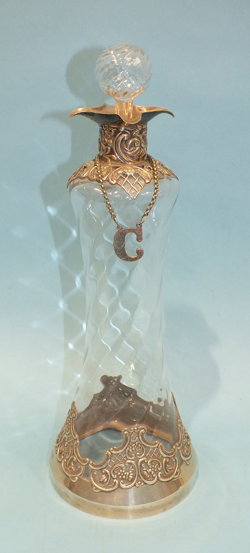 A Late-Victorian glass decanter and stopper, the decanter of tapering waisted form, with embossed