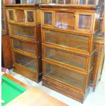 A pair of Globe-Wernicke-style mahogany and stained wood sectional bookcases, each with four