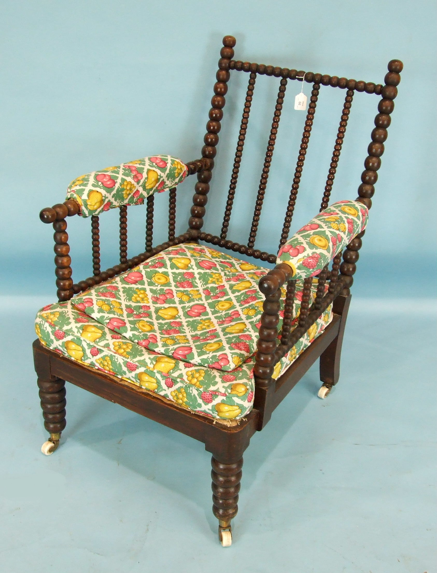 A Late-Victorian hardwood bobbin-turned chair, the pierced bobbin-turned frame with partially-padded