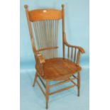 An oak and elm rustic open-back kitchen chair, the stick back and galleried arms with solid seat, on