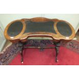 A Victorian inlaid walnut ladies writing table, the shaped top with writing surfaces, the pen tray